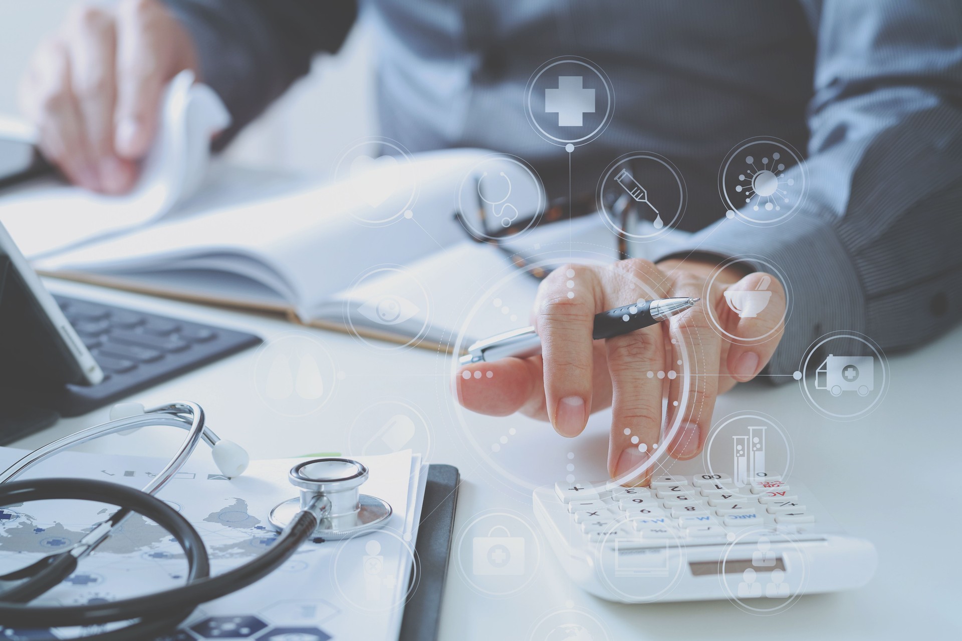 Healthcare costs and fees concept.Hand of smart doctor used a calculator for medical costs in modern hospital